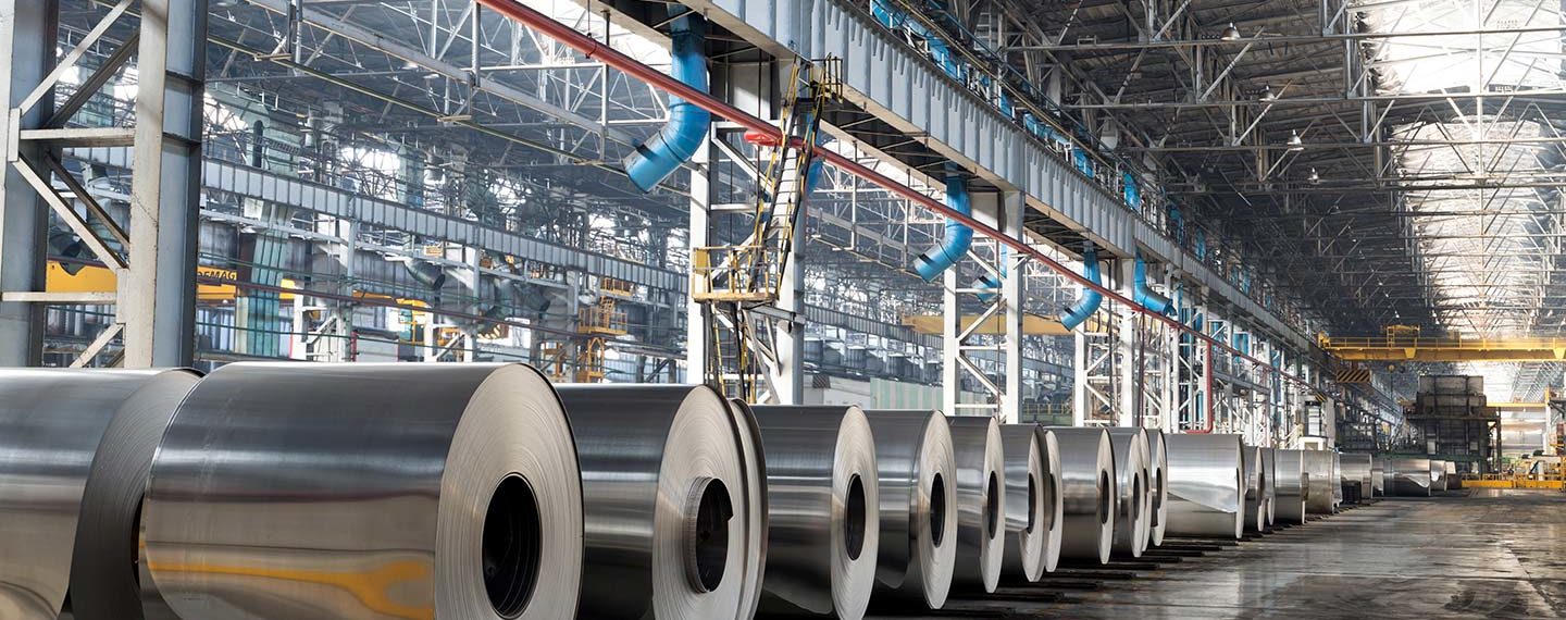 row of large steel rolls in a warehouse