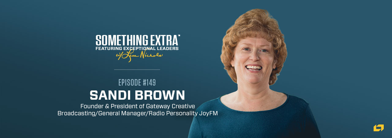 a poster for something extra featuring Sandi Brown
