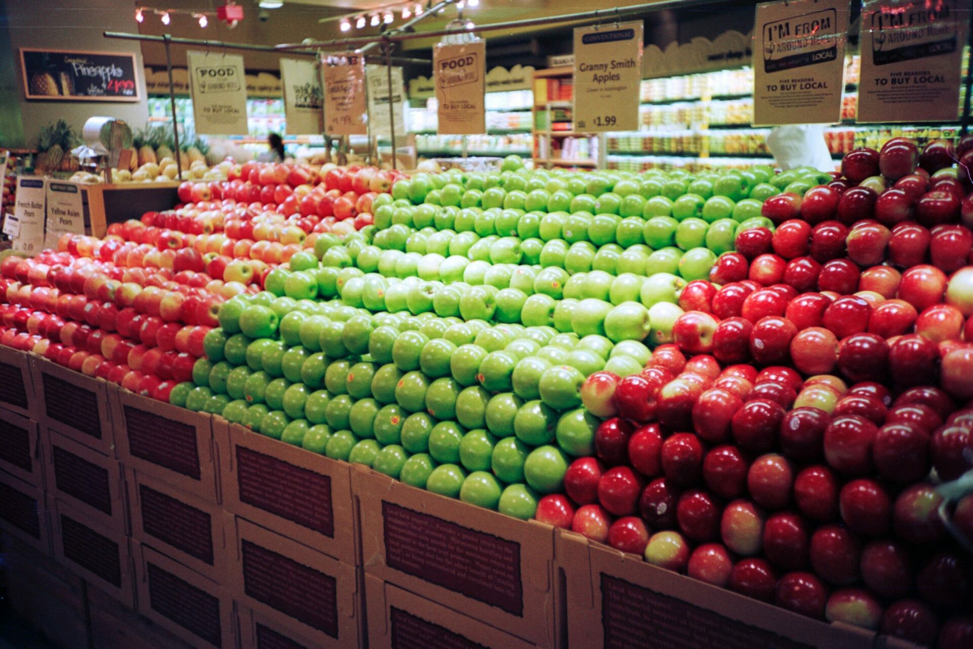 grocery store display of red and green apples